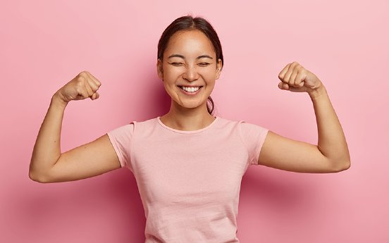 strong-powerful-asian-woman-with-dark-combed-hair-toothy-smile-raises-arms-and-shows-biceps-has-.jpg