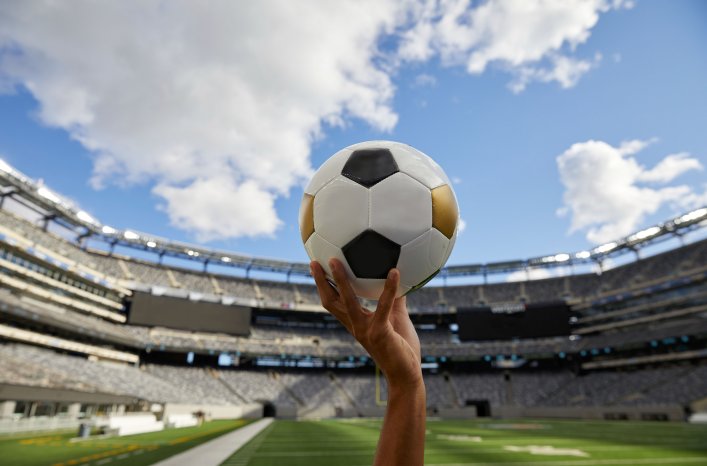 Hand-holding-ball-MetLife-stadium-NYC-Courtesy-New-York-New-Jersey-2026-World-Cup-Host-Committee.jpg