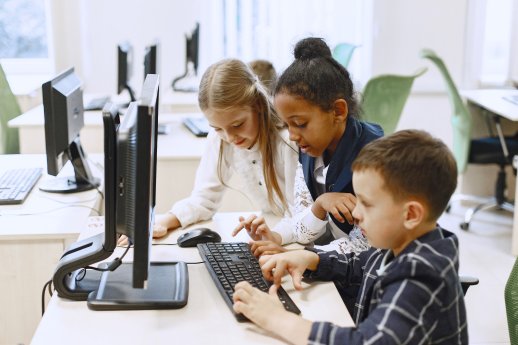 guy-girl-are-sitting-table-african-girl-computer-science-class-kids-playing-computer-games_.jpg