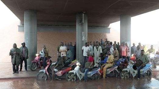 Oil workers (of the Shell company of Nigeria) returning form work, caught in torrrential rain, 2013