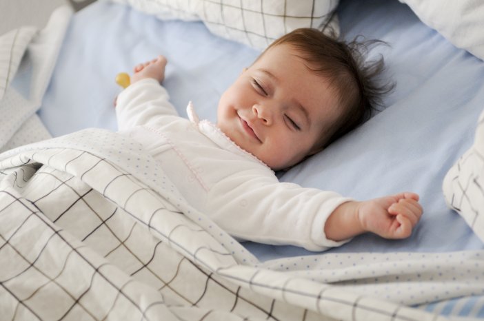 freepik-javi_indy-smiling-baby-lying-on-a-bed.jpg