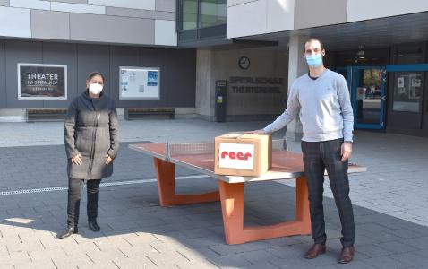 Tobias Mörk, reer GmbH, überreichte am Mittwochmorgen ein großes Paket mit 600 Mundschutzmasken an Frau Khalegi, Vorstand des Fördervereins der Spitalschule.