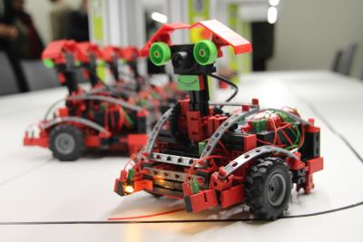 Fahrbare Roboter aus einer Modellbaureihe von Fischertechnik können mit unterschiedlichen Sensoren bestückt sowie mittels PC, Tablet oder Smartphone-App programmiert und gesteuert werden. So lassen sich verschiedenste Straßenverkehrssituationen simulieren und Anforderungen an zukünftige Systeme zum autonomen Fahren vermitteln / Fotograf / Quelle: TH Wildau / Bernd Schlütter