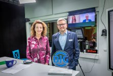 Moderatorin Steffi Strecker und BIG-Vorstandsvorsitzender Peter Kaetsch im Livestream-Studio, im Hintergrund auf den Bildschirmen Teresa Enke und Prof. Dr. Ulrich Hegerl.