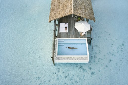 COMO_Cocoa_Island_Aerial_One bedroom Water Villa_Terrace with couple.jpg