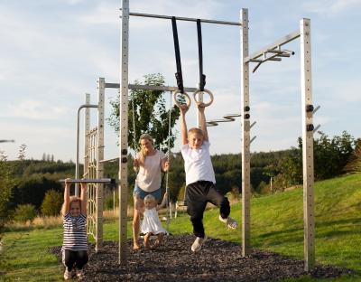 Die ganze Familie trainiert an einer Fitness-Station im eigenen Garten.