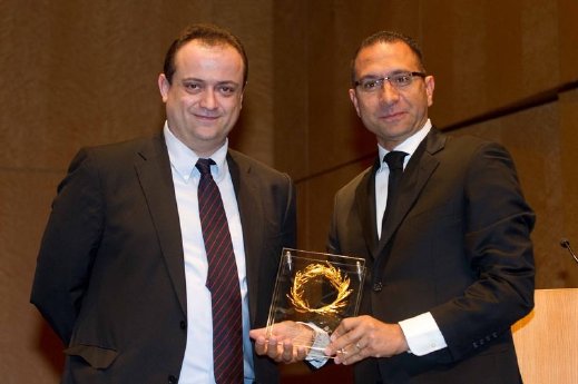 Ahmed Youssef, Regional Director Amadeus MENA, received the trophy from Dr Kostas Iatrou, M.JPG