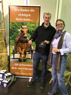 Markus Holzmann am Messestand von Michéle Mesche, die ihm für seine Seelenkuh Emmi Hufschuhe gesponsert für seine Wanderung gesponsert hat