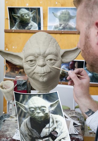 Sculptor Bradley Simms checks a reference picture whilst working on his clay sculpt of Yoda at M.JPG