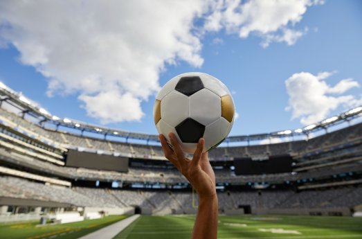 Hand-holding-ball-MetLife-stadium-NYC-Courtesy-New-York-New-Jersey-2026-World-Cup-Host-Committee.jpg