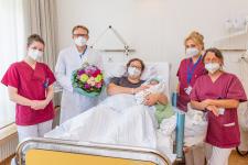 Prof. Andreas Müller überreicht Mutter Cornelia Gerome einen Blumenstrauß, Bildquelle: Markus Kümmerle, Städtisches Klinikum Karlsruhe