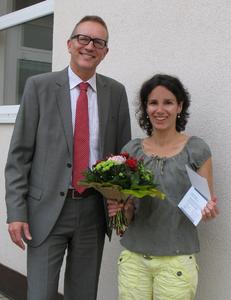 Christian Schrader, Niederlassungsleiter der TÜV SÜD Akademie Freiburg, überreicht Yasmin Mack einen Seminargutschein im Wert von 500 Euro. Foto: TÜV SÜD