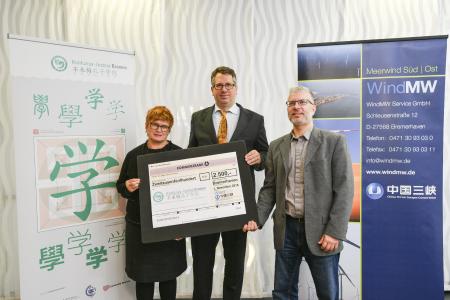 Prof. Dr. Karin Luckey, Rektorin der Hochschule Bremen und Vorstandsvorsitzende des KIB e.V. empfängt von Jens Assheuer, Geschäftsführer der WindMW Service GmbH, und Knut Schulze, Dipl.-Ing.(FH) Architekt, WindMW Service GmbH, den Scheck zur Förderung der Teilnahme Bremer und Bremerhavener Studierender an den vom KIB e.V. organisierten Sommercamps / Fotograf: Karsten Klama
